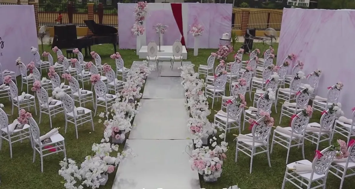 Garden aisle with white chairs and blush florals