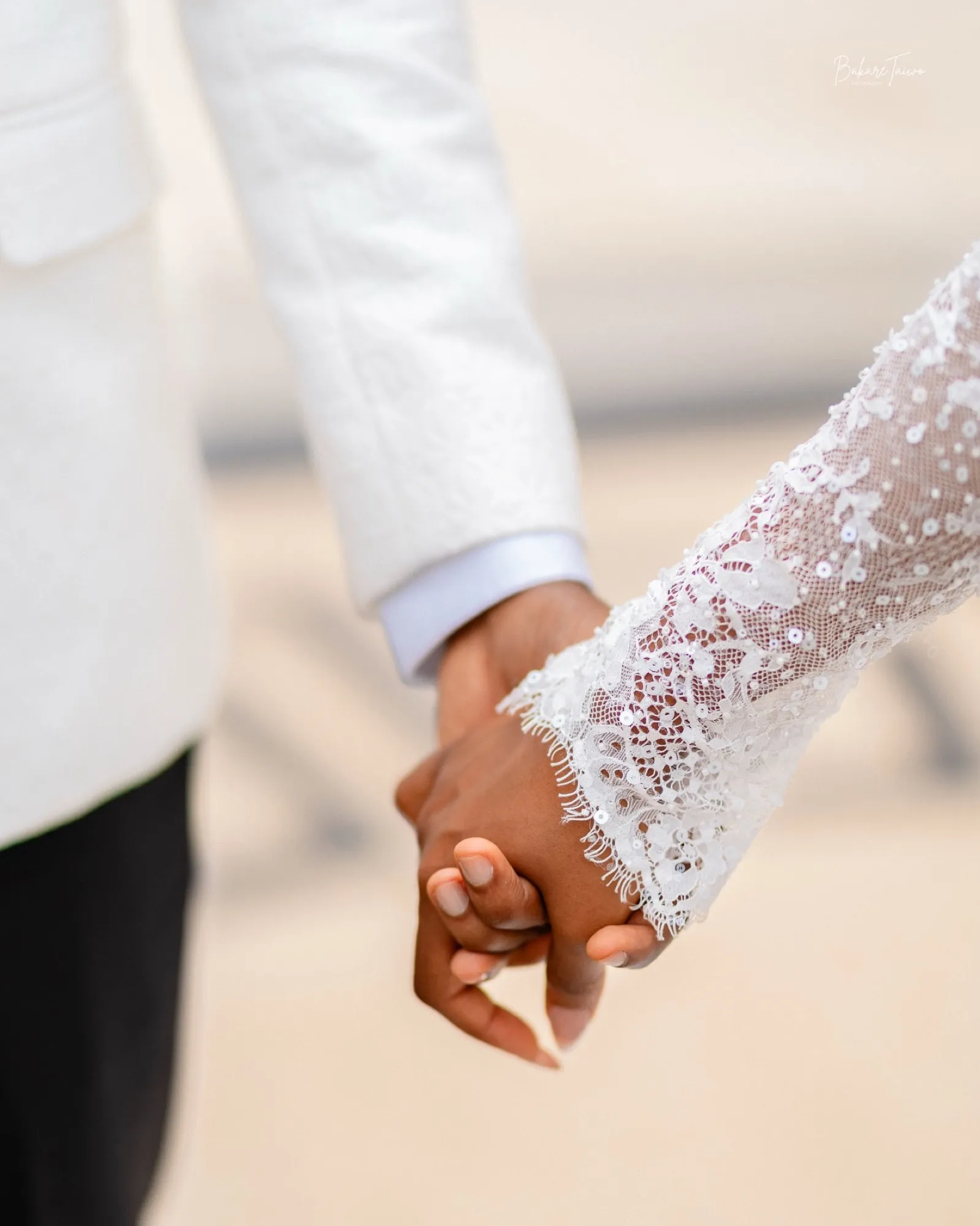 Holding hands, lace sleeve and white tux