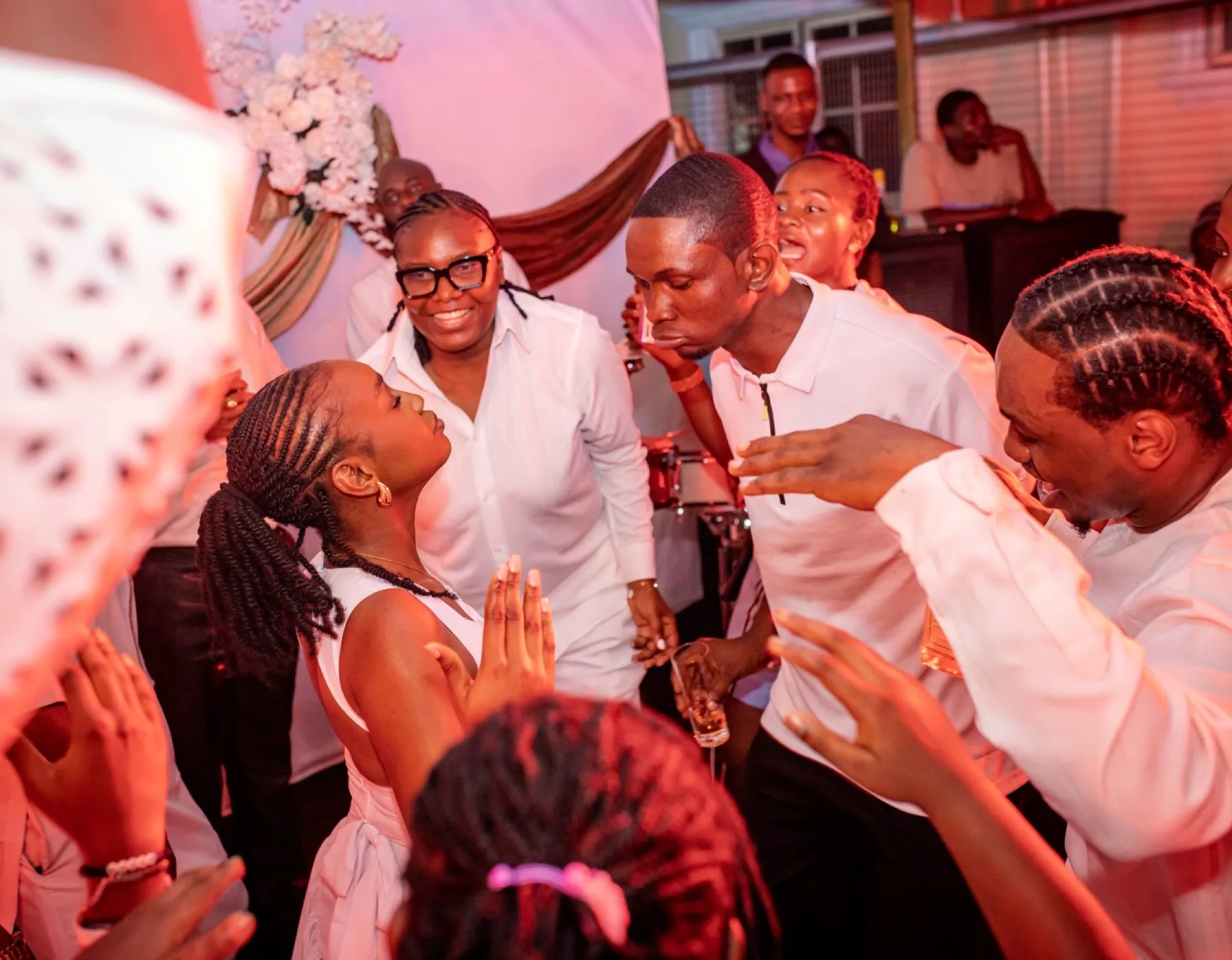Guests cheering on the dance floor in warm light