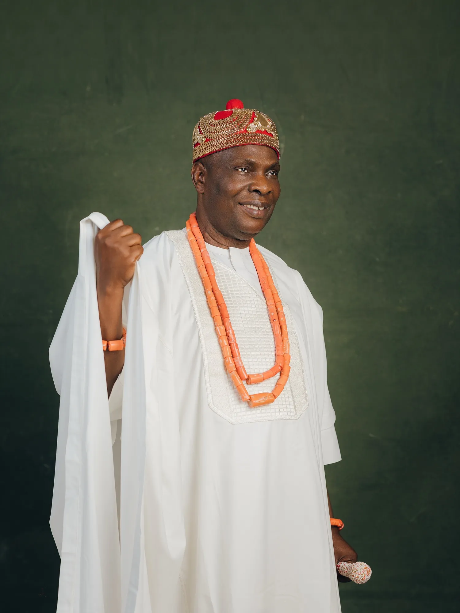 HRM in white agbada, coral beads and a beaded crown