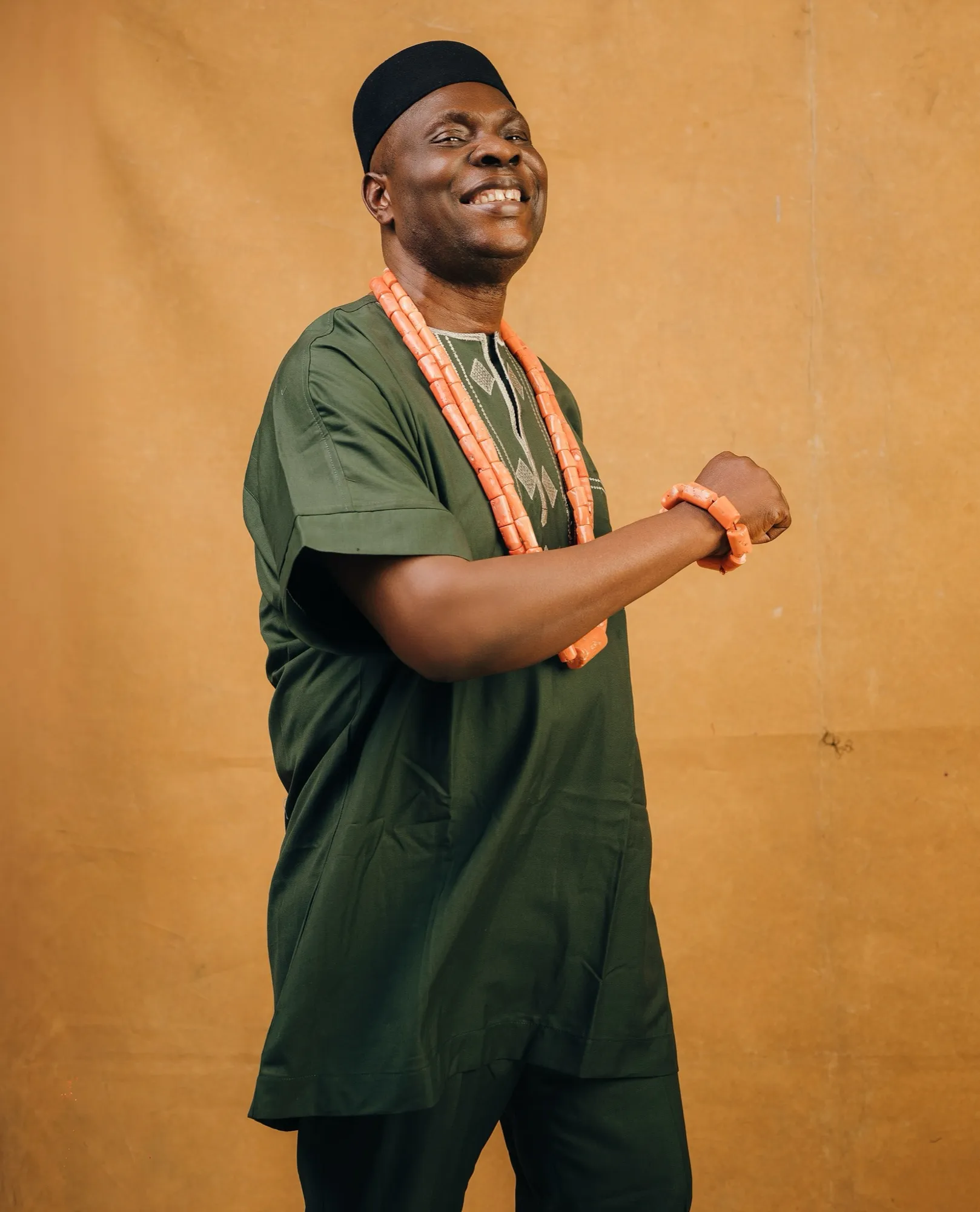 HRM dancing in green attire and coral beads