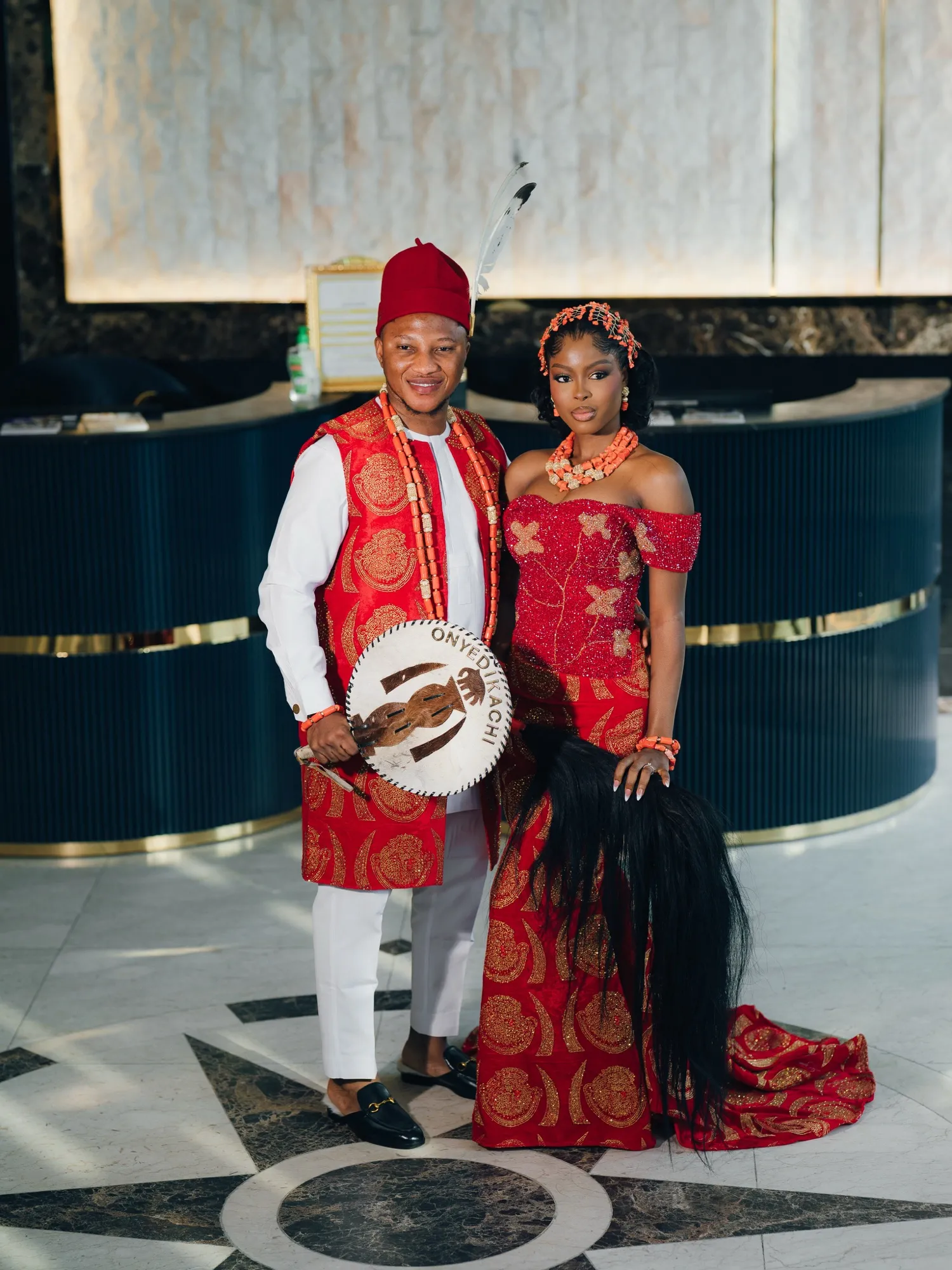 The couple in matching red and white traditional attire
