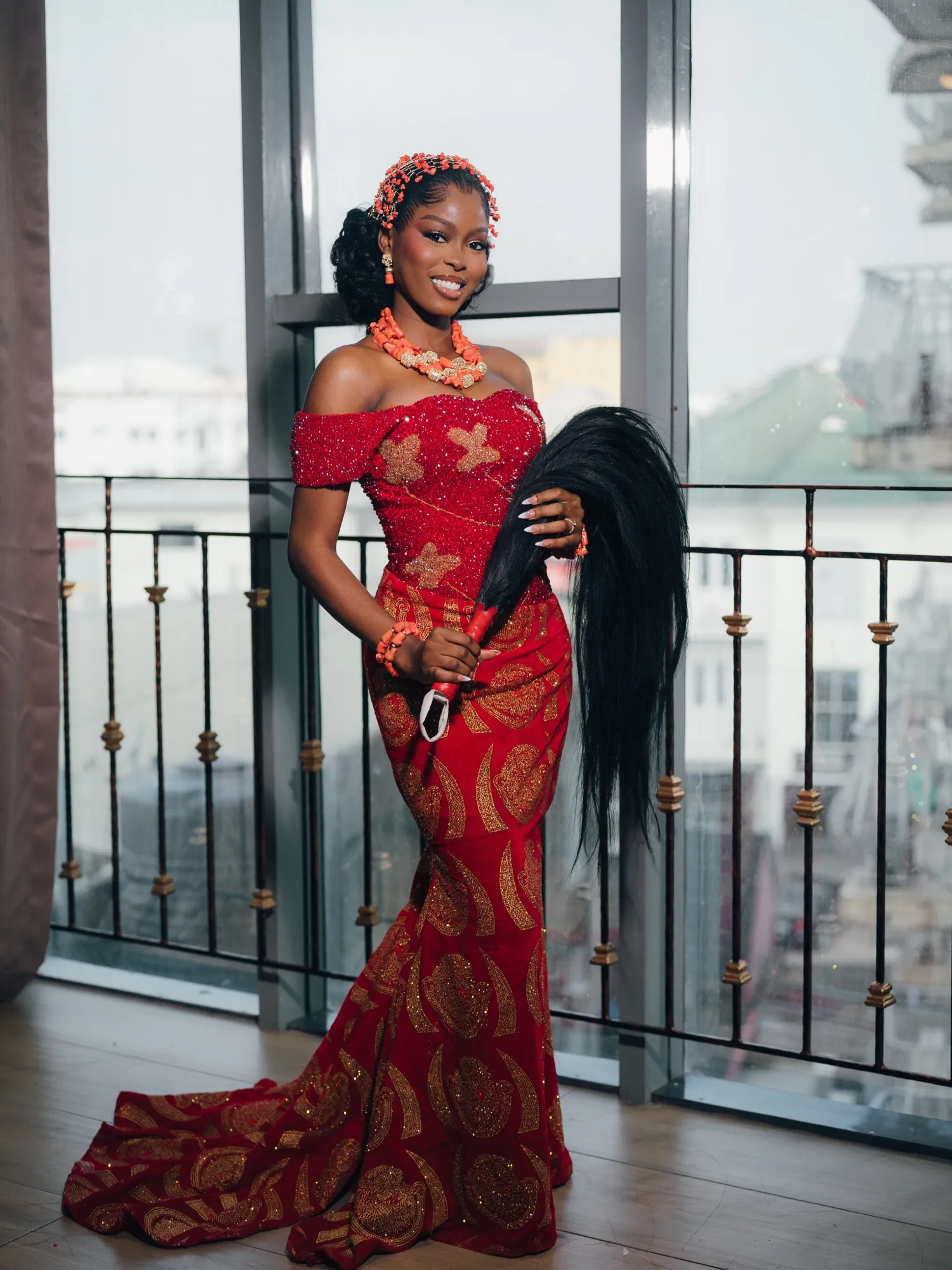 Feyi in red lace and coral beads for the traditional wedding