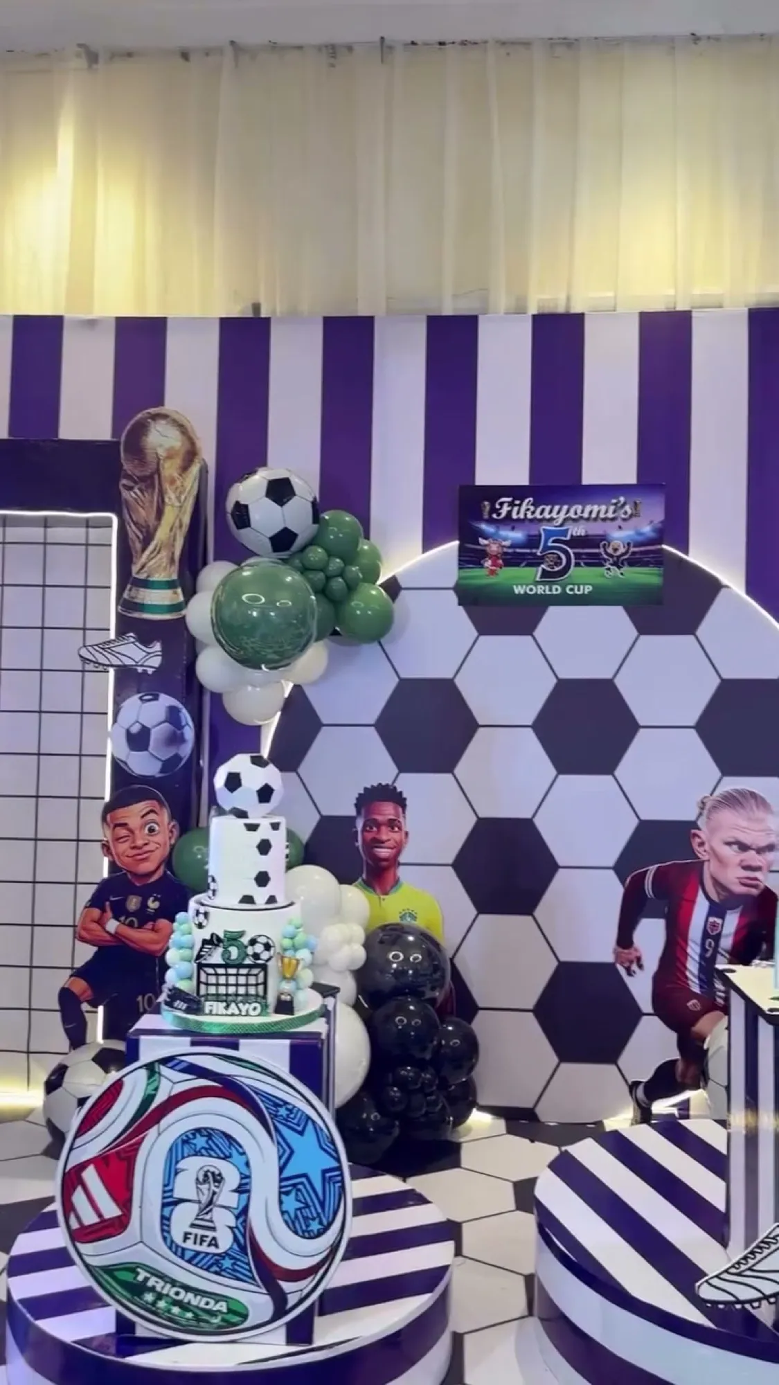Striped stadium backdrop with a football-print plinth