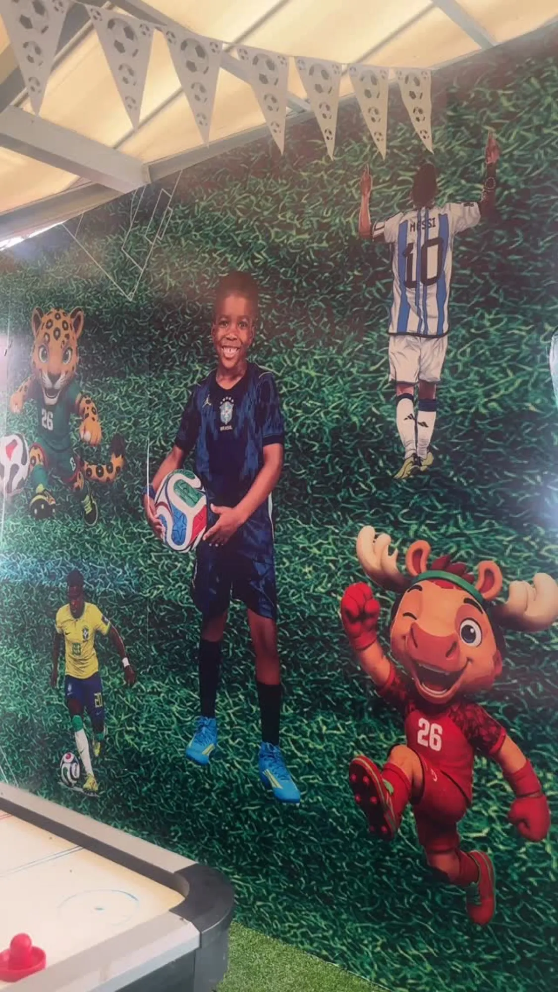 Cartoon footballer cut-outs at the entrance