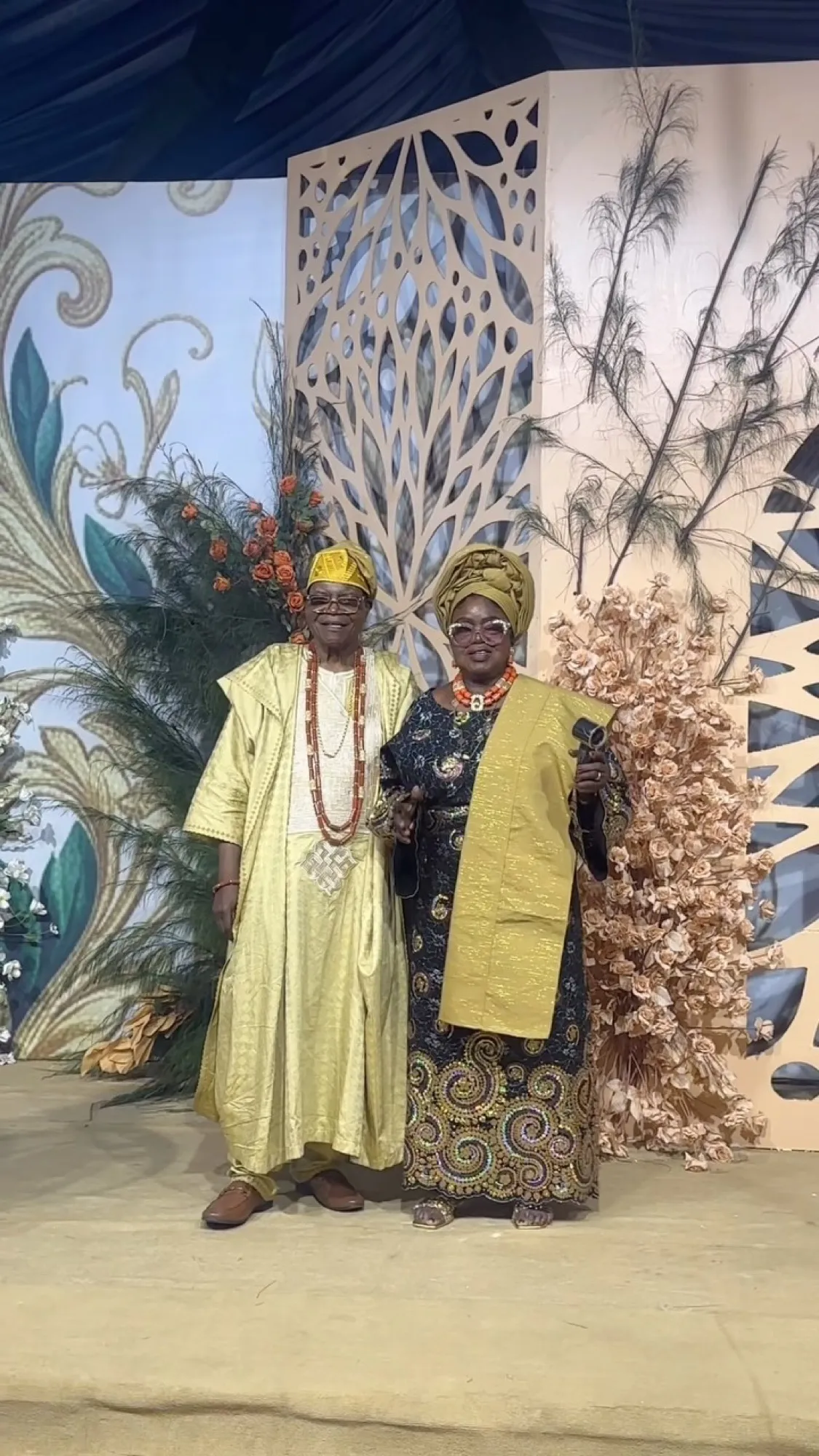 Mr and Mrs Ishola at the stage backdrop